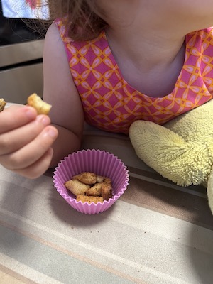 Baby holding a homemade garlic crouton.