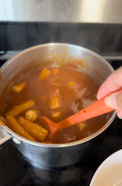 Tteokbokki (Korean spicy rice cakes) cooking in a saucepan